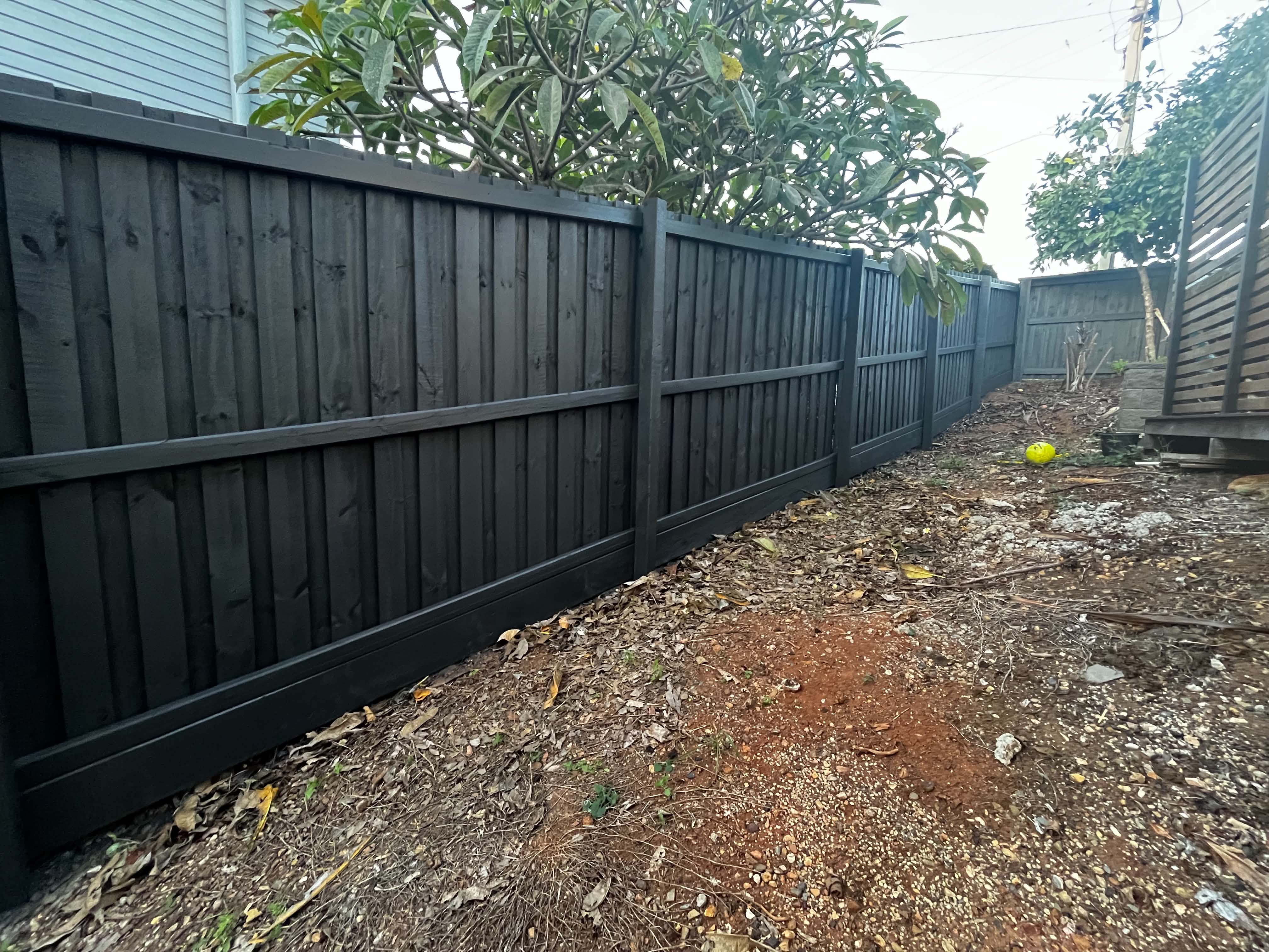 Timber fence after dark protective coating